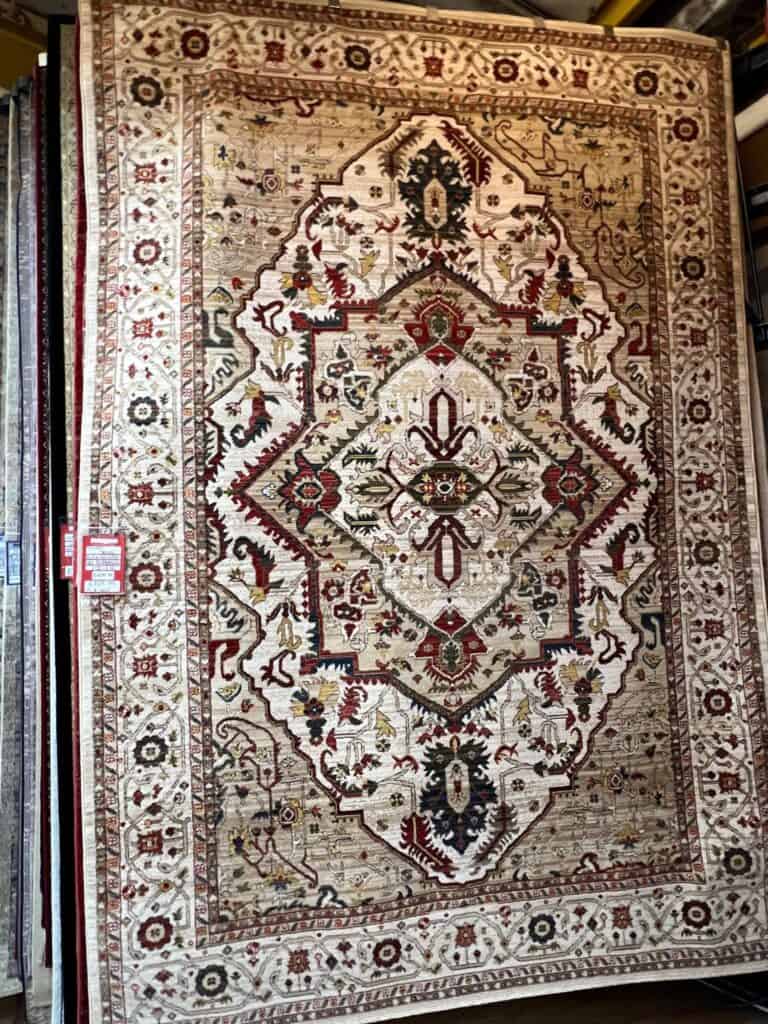Traditional multicoloured pattern on a cream background with a cream border.