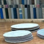 Image showing the pile of circle rugs in our showroom.