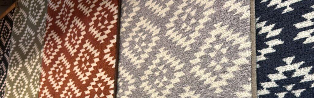 Colourful geometric patterned aztec rugs display in different hues at Fringes of Plymouth.